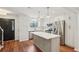 Well-designed kitchen and island adjacent to the stairs and black front door at 1245 S Ponce De Leon Ne Ave # 13, Atlanta, GA 30306