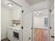 Bright laundry area features a front-load washer and dryer, with extra storage above at 1245 S Ponce De Leon Ne Ave # 13, Atlanta, GA 30306