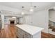 Open-concept kitchen with island flows into living space featuring fireplace, wood floors, and natural light at 1245 S Ponce De Leon Ne Ave # 13, Atlanta, GA 30306
