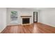 Spacious living room featuring hardwood floors, fireplace, and natural light from window at 1245 S Ponce De Leon Ne Ave # 13, Atlanta, GA 30306