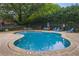 Community pool surrounded by lounge chairs, tables, and plenty of shade at 1245 S Ponce De Leon Ne Ave # 13, Atlanta, GA 30306