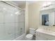 Bright bathroom featuring shower with glass door, toilet and vanity with sink at 3639 Paper Mill Se Rd, Marietta, GA 30067