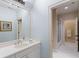 Bright bathroom featuring a large mirror, and sinks and shower with glass door at 3639 Paper Mill Se Rd, Marietta, GA 30067
