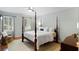 Bright bedroom with four poster bed, hardwood floors and a sitting area at 3639 Paper Mill Se Rd, Marietta, GA 30067