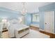Light blue bedroom with white accents, chandelier, and a window seat creates a cozy feel at 3639 Paper Mill Se Rd, Marietta, GA 30067