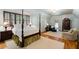 Spacious bedroom featuring a four poster bed, sitting area and chandelier at 3639 Paper Mill Se Rd, Marietta, GA 30067