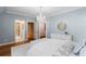 Bright bedroom featuring a chandelier, ensuite bath access and light blue walls at 3639 Paper Mill Se Rd, Marietta, GA 30067