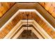 Close-up of vaulted ceiling with wood paneling, beams, crown molding and an ornate pendant light fixture at 3639 Paper Mill Se Rd, Marietta, GA 30067