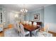 Formal dining room with elegant chandelier, large table, and decorative rug at 3639 Paper Mill Se Rd, Marietta, GA 30067