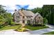 Stately home with stone and siding exterior, lush landscaping, and a winding driveway at 3639 Paper Mill Se Rd, Marietta, GA 30067