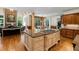 Open kitchen concept with central island, stone fireplace, and views into the living room at 3639 Paper Mill Se Rd, Marietta, GA 30067
