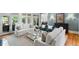 Living room with hardwood floors, ample lighting, and multiple seating areas at 3639 Paper Mill Se Rd, Marietta, GA 30067