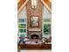 Inviting living room featuring a stone fireplace, vaulted ceilings, and a view of the backyard pool at 3639 Paper Mill Se Rd, Marietta, GA 30067