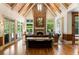 Bright and airy living room featuring a stone fireplace, vaulted ceilings, and a view of the backyard pool at 3639 Paper Mill Se Rd, Marietta, GA 30067