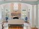 Main bedroom sitting area with stone fireplace, plush seating, and natural light at 3639 Paper Mill Se Rd, Marietta, GA 30067