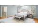 Elegant main bedroom with a tufted headboard and natural light at 3639 Paper Mill Se Rd, Marietta, GA 30067