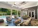 Spacious outdoor living area with plush seating, ceiling fans, and a stunning view of the backyard pool and pergola at 3639 Paper Mill Se Rd, Marietta, GA 30067