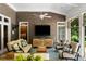 Cozy covered patio featuring comfortable seating, a ceiling fan, and outdoor television with a view of the backyard at 3639 Paper Mill Se Rd, Marietta, GA 30067