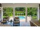 Inviting covered patio featuring comfortable seating and a view of the sparkling pool and manicured backyard at 3639 Paper Mill Se Rd, Marietta, GA 30067