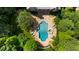 Aerial view of a luxurious pool with a spa, surrounded by lounge chairs and lush landscaping at 3639 Paper Mill Se Rd, Marietta, GA 30067