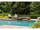 Inviting pool with elevated stone waterfall and serene seating area at 3639 Paper Mill Se Rd, Marietta, GA 30067