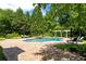 Luxurious pool with stone waterfall feature, surrounded by verdant landscaping at 3639 Paper Mill Se Rd, Marietta, GA 30067