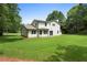 Backyard of the home showcasing a well maintained lawn and the back exterior of the house at 3729 Meadow Glen Cir, Ellenwood, GA 30294