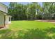 A well maintained and spacious backyard with lush green grass and tree line in the back at 3729 Meadow Glen Cir, Ellenwood, GA 30294