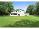 Backyard of the home showcasing a well maintained lawn and the back exterior of the house at 3729 Meadow Glen Cir, Ellenwood, GA 30294