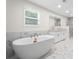 Bathroom showcasing a standalone tub, marble shower, and granite double sink at 3729 Meadow Glen Cir, Ellenwood, GA 30294