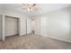 Bedroom featuring carpet flooring, ceiling fan, closet with white bi-fold doors, and ensuite bath at 3729 Meadow Glen Cir, Ellenwood, GA 30294