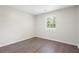 An empty bedroom showcases a window and hardwood flooring at 3729 Meadow Glen Cir, Ellenwood, GA 30294