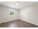 An empty bedroom showcases a window and hardwood flooring at 3729 Meadow Glen Cir, Ellenwood, GA 30294