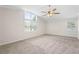 This bedroom features neutral walls, carpet and a modern ceiling fan with large windows at 3729 Meadow Glen Cir, Ellenwood, GA 30294