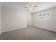 This bedroom features neutral walls, carpet, a ceiling fan and window at 3729 Meadow Glen Cir, Ellenwood, GA 30294