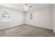 Carpeted bedroom with two windows allowing plenty of natural light and neutral colored walls at 3729 Meadow Glen Cir, Ellenwood, GA 30294