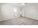 This bedroom features neutral walls, carpet and has a view into another room at 3729 Meadow Glen Cir, Ellenwood, GA 30294