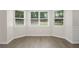 Bright dining area featuring hardwood floors and lots of natural light from the bay window at 3729 Meadow Glen Cir, Ellenwood, GA 30294