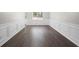 Bright dining room featuring hardwood floors, classic wainscoting, and a large window at 3729 Meadow Glen Cir, Ellenwood, GA 30294