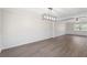 The dining area has wood floors, wainscotting, a modern light fixture, and large windows at 3729 Meadow Glen Cir, Ellenwood, GA 30294