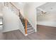 A lovely foyer with stairs, wood railing and a partial view into another room at 3729 Meadow Glen Cir, Ellenwood, GA 30294