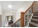 An elegant foyer with a skylight, chandelier, decorative railing, and front door view at 3729 Meadow Glen Cir, Ellenwood, GA 30294