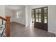 Bright foyer with hardwood floors, white trim, and a view of the staircase and living area at 3729 Meadow Glen Cir, Ellenwood, GA 30294