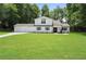 Charming two-story home features a manicured lawn, a two-car garage, and classic black shutters at 3729 Meadow Glen Cir, Ellenwood, GA 30294