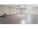Spacious two car garage with light gray epoxy flooring, white doors, and a window for natural light at 3729 Meadow Glen Cir, Ellenwood, GA 30294