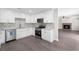 Modern kitchen with white cabinets, granite countertops, tile backsplash, and stainless steel appliances at 3729 Meadow Glen Cir, Ellenwood, GA 30294