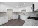 Modern kitchen with white cabinets, granite countertops, tile backsplash, and stainless steel appliances at 3729 Meadow Glen Cir, Ellenwood, GA 30294