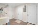 Clean laundry room featuring hardwood floors, utility sink, laundry connections and access to the backyard at 3729 Meadow Glen Cir, Ellenwood, GA 30294