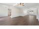 Spacious living room boasts dark wood floors, wainscotting, and ceiling fan with views to the entryway at 3729 Meadow Glen Cir, Ellenwood, GA 30294