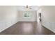 Bright and airy living room shows off wood floors, wainscotting, ceiling fan and natural light at 3729 Meadow Glen Cir, Ellenwood, GA 30294